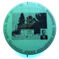 Political button for Emil Matalik's campaign, c. 1972, featuring a photo of his home at centre, the U.n.o. flag flying, with a photo portrait of Matalik at lower right.